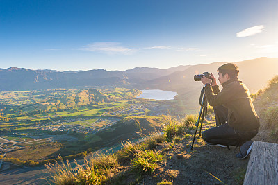 Young travler taking photo at queen town  in new zealand