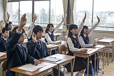 Japanese raising their hands up about the question