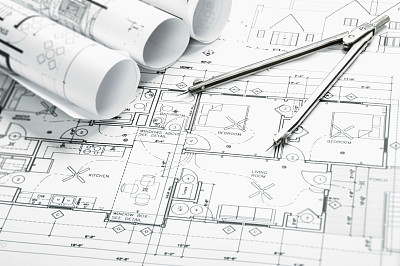 Architectural blueprints and blueprint rolls with drawing instruments