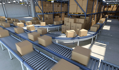 Boxes moving on conveyor belt inside warehouse, ready for delivery