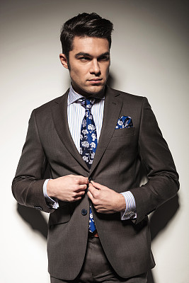 Handsome business man closing his jacket