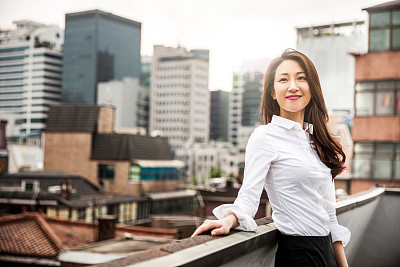 Smiling young business woman in Seoul downtown