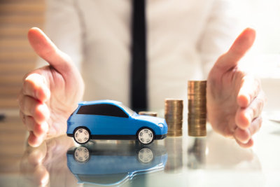Person Protecting Increasing Stacked Coins And Car