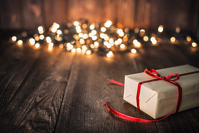 Christmas Gift on Old Plank and defocused lights