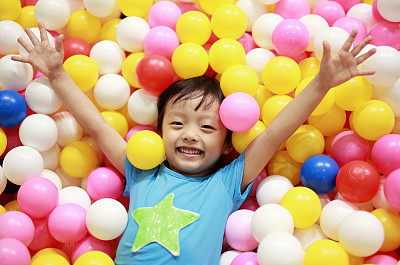 Kids playing at a ball pool