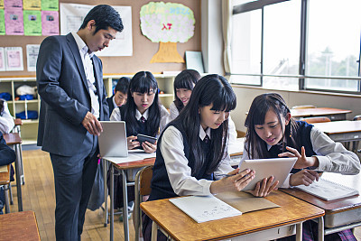 Japanese kids working with digital tablets at school