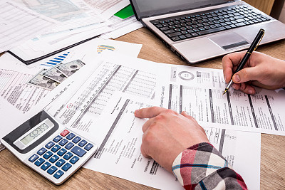 businessman making report, calculating or checking balance.