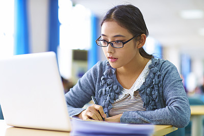 pretty college student study in library