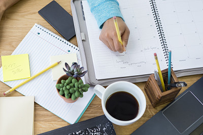 Woman writes in personal organizer