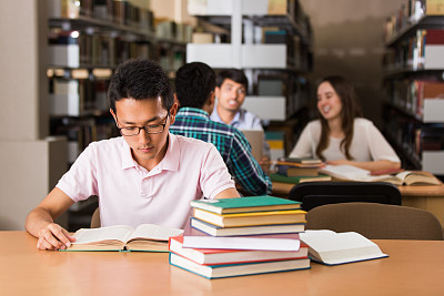 Korean student reading a book in the library