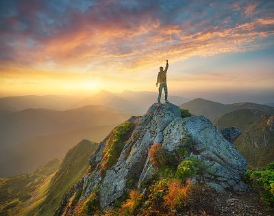 Silhouette of a champion on mountain peak