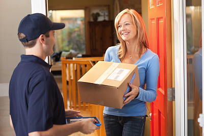 Delivery Person Delivering Box, Container Package to Residential Home