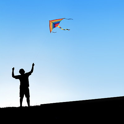 Man and a kite in the sky