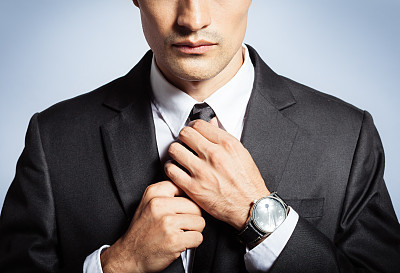 Man in the suit fixing his tie