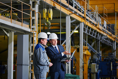 Man in a suit and a worker in overalls