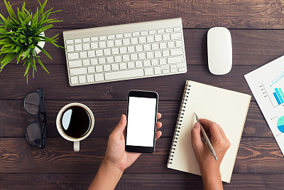 hand holding phone white screen and write note