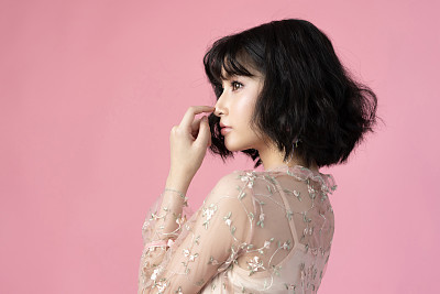 Portrait beautiful woman asian with clean skin, natural make-up,she used her nose,pink background