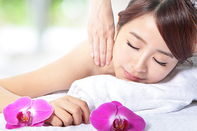 beautiful woman getting spa massage on shoulder