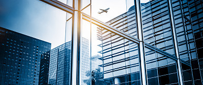 Business towers with an motion  airplane silhouette