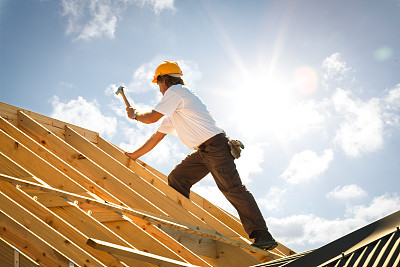 roofer carpenter working on roof