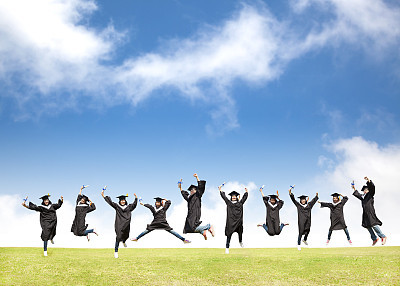 College students celebrate graduation and happy jump