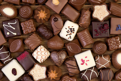 Assorted chocolate pralines on wooden background