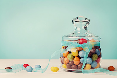 Colorful candy jar decorated with bow ribbon, gifts for Birthday