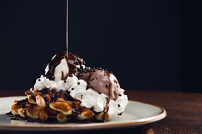 Ice cream with chocolate sauce and waffle