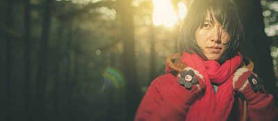 Asian young woman standing in the jungle of pine trees.