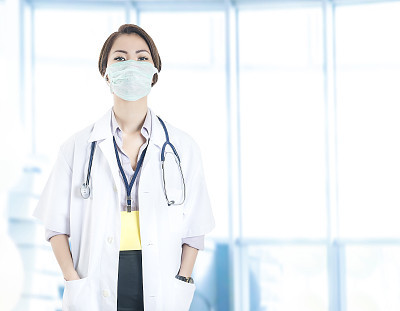 Female Surgical Nurse looking at the camera with surgical mask