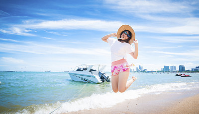 Beautiful young woman having fun on beach