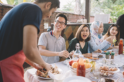 carving a chicken with friends and family