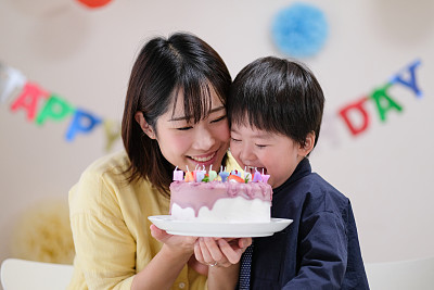Mother celebrating her son's birthday at home