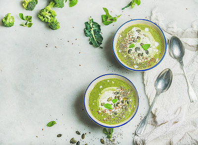 Broccoli cream soup with mint and coconut cream, copy space
