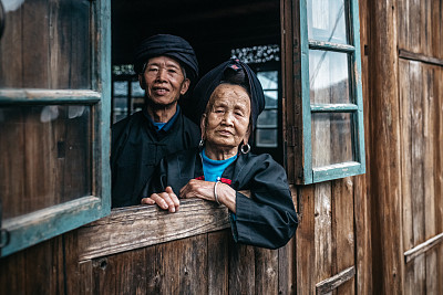 old chinese couple looking out of window