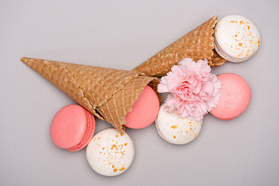 colorful macarons in waffle cones with Carnation flower