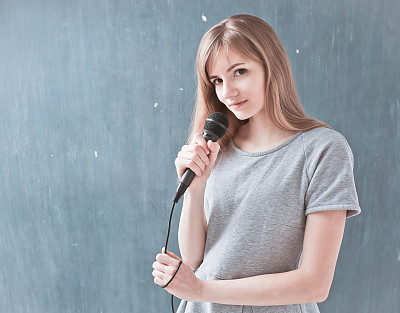 woman singing into a microphone