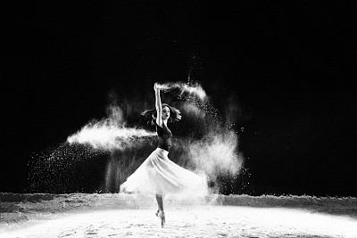 Beautiful ballet dancer, dancing with powder on stage