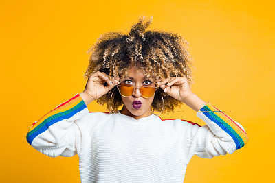 Funky afro girl against yellow background