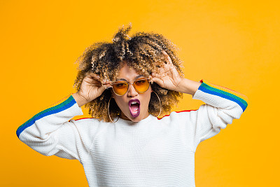 Funky afro girl against yellow background