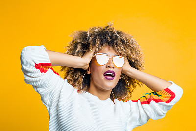 Funky afro girl against yellow background