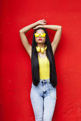 Woman in yellow vest and sunglasses with long hair