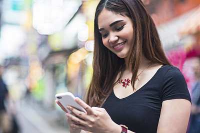 Young Philippine woman using the mobile phone