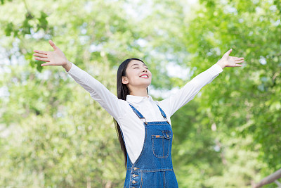 young brunette girl with open arms, freedom sensation