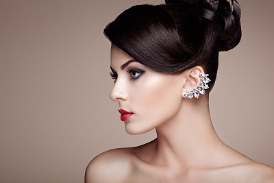 Fashion portrait of young beautiful woman with elegant hairstyle