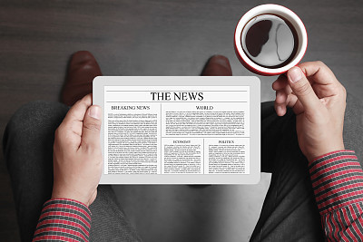Man reading news on digital tablet