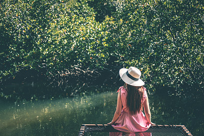 Woman relaxing in mangrove forest Lagoon vacation time