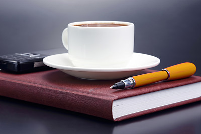 the red pen is a saucer Cup of black coffee