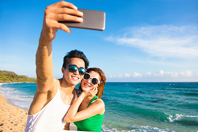 young couple  taking vacation selfie photograph at the beach  young couple  taking vacation selfie photograph at the beach