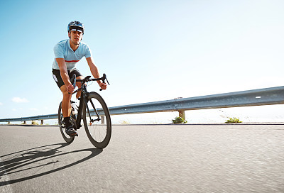 Man riding a bicycle on scenic road